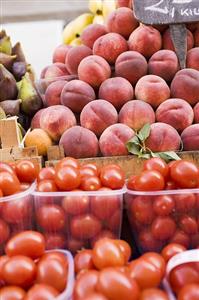 Tomatoes and peaches at a market