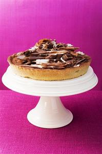 Whole chocolate tart on cake stand