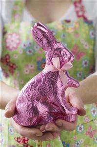 Woman holding Easter Bunny in pink foil