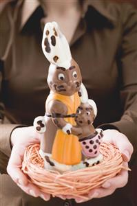 Woman holding chocolate bunnies in Easter nest