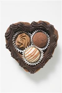 Three chocolates in a chocolate heart