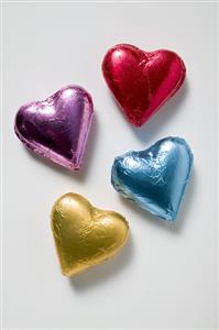 Four chocolate hearts in coloured foil