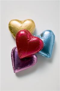 Four chocolate hearts in coloured foil