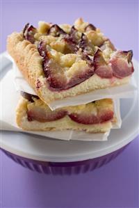 Two pieces of plum cake on plastic bowl