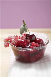 Red berry compote in glass dish