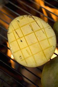 Mango on barbecue grill rack