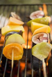 Fruit kebabs on barbecue grill rack