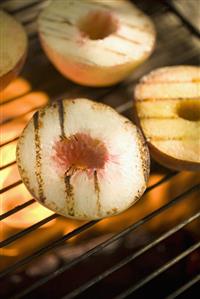 Peaches on a barbecue grill rack