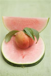 Nectarine with leaves, slice and wedge of watermelon