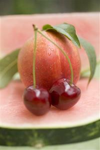 Nectarine with leaves, watermelon and cherries