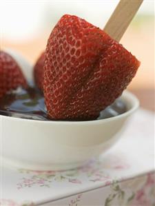 Strawberry on stick in chocolate sauce