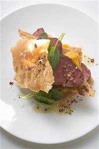 Beef fillet between sheets of pastry with basil and mango