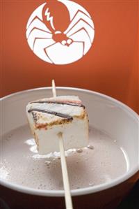 Cocoa with marshmallow on stick for Halloween