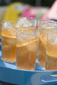 Several glasses of iced tea on a tray