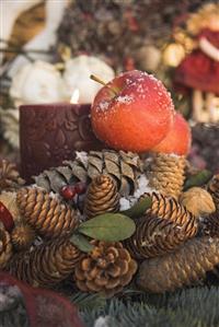 Christmas decorations: cones, red apples and candle