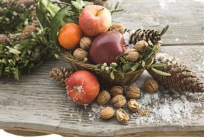 Rustic Christmas decoration with apples, nuts and cones