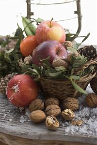 Rustic Christmas decoration with apples, nuts and cones