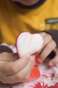 Child's hand holding sugar heart