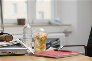 Fruit salad and bottle of water in office