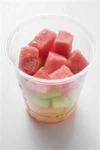 Diced melon and watermelon in plastic tub