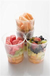 Fresh fruit in four plastic tubs