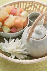 Fruit salad and tea in basket