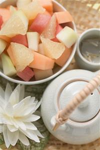 Fruit salad and tea in basket (overhead view)