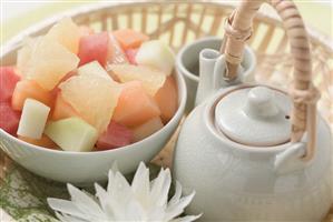 Fruit salad and tea in basket