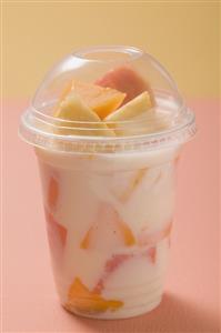 Yoghurt with fresh fruit in plastic pot