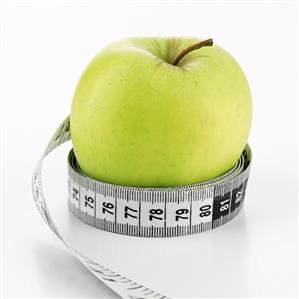 Green apple with tape measure