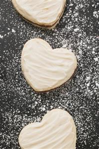 Three heart-shaped Christmas biscuits (overhead view)