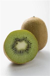 Whole kiwi fruit and half a kiwi fruit