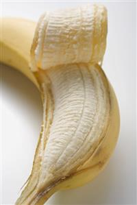 Banana, partly peeled (close-up)