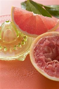 Pink grapefruit wedge, squeezed grapefruit, citrus squeezer