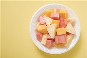 Exotic fruit salad in plastic dish (overhead view)