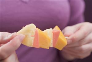 Woman holding exotic fruit skewers