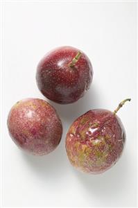 Three purple passion fruits