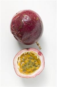 Purple passion fruits, whole and half