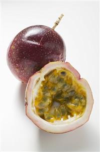 Purple passion fruits, whole and half