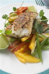 Spicy pangasius fillet with vegetables, lime, coriander