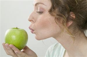 Woman holding green apple