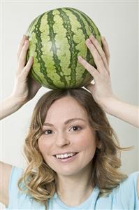 Woman balancing watermelon on her head