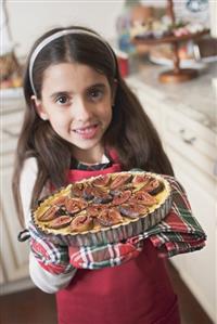 Girl holding freshly-baked fig tart