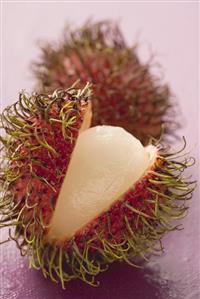 Rambutans, whole and cut open