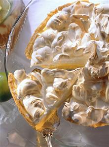 Lime pie with meringue on round glass plate (1)