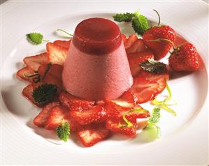 Molded strawberry mousse on fresh strawberries