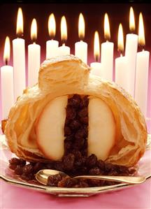 Baked apple in puff pastry with raisin filling on plate