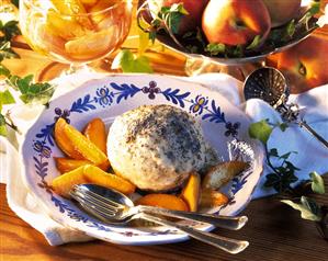 Yeast dumpling with stewed peach wedges on plate