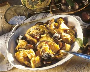 Emperor's pancake with damsons and almond flakes in bowl