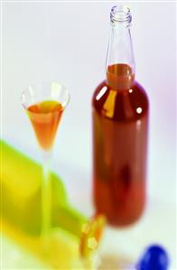 Damson liqueur in glass and bottle